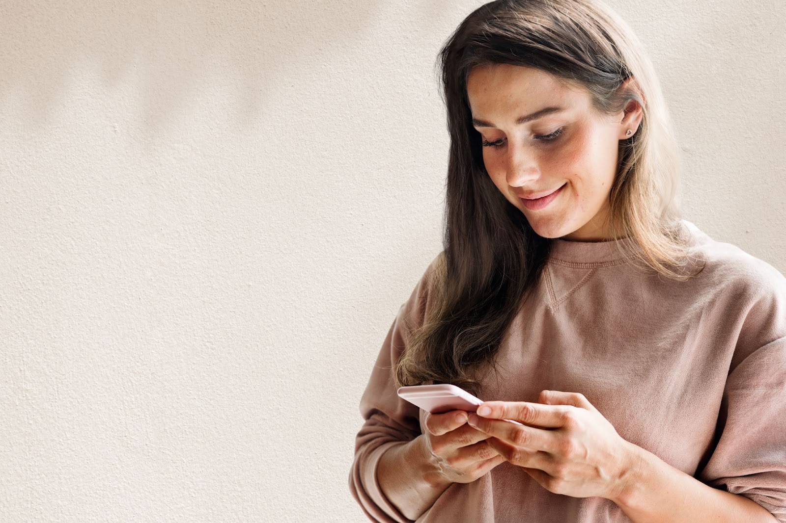 Woman holding a smartphone and smiling