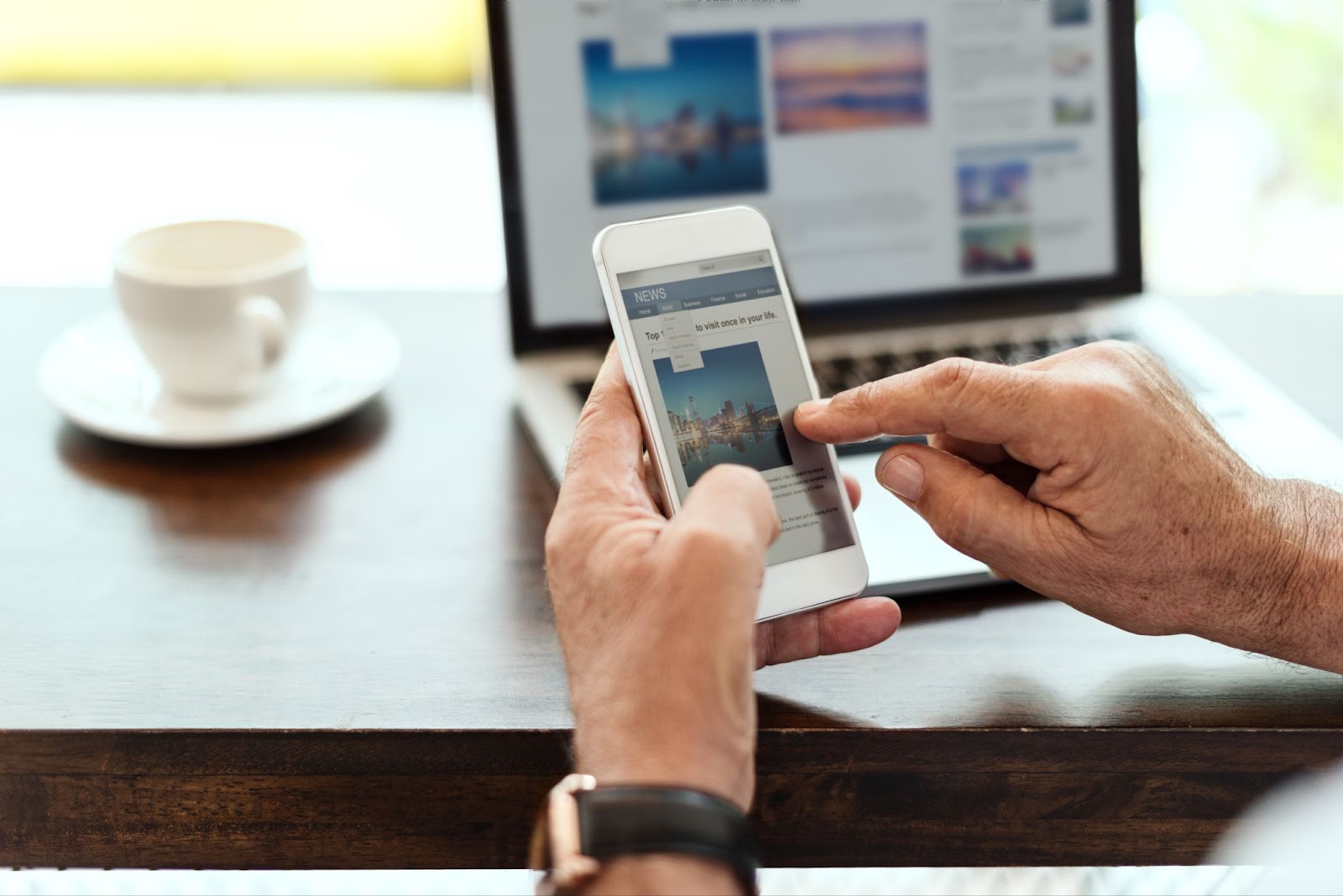 Elderly man is using mobile phone and read news